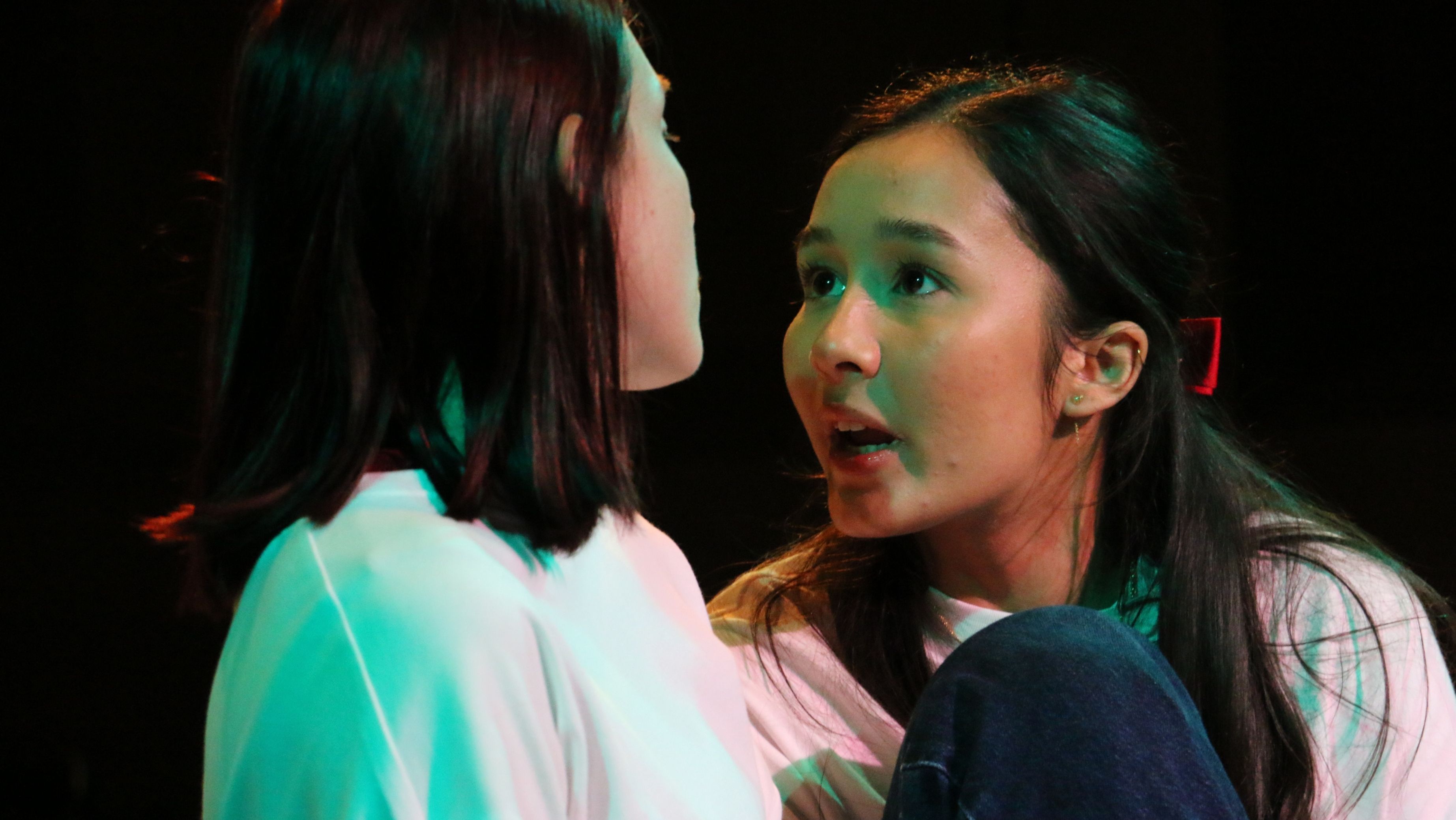 Show time 2 young women facing each other